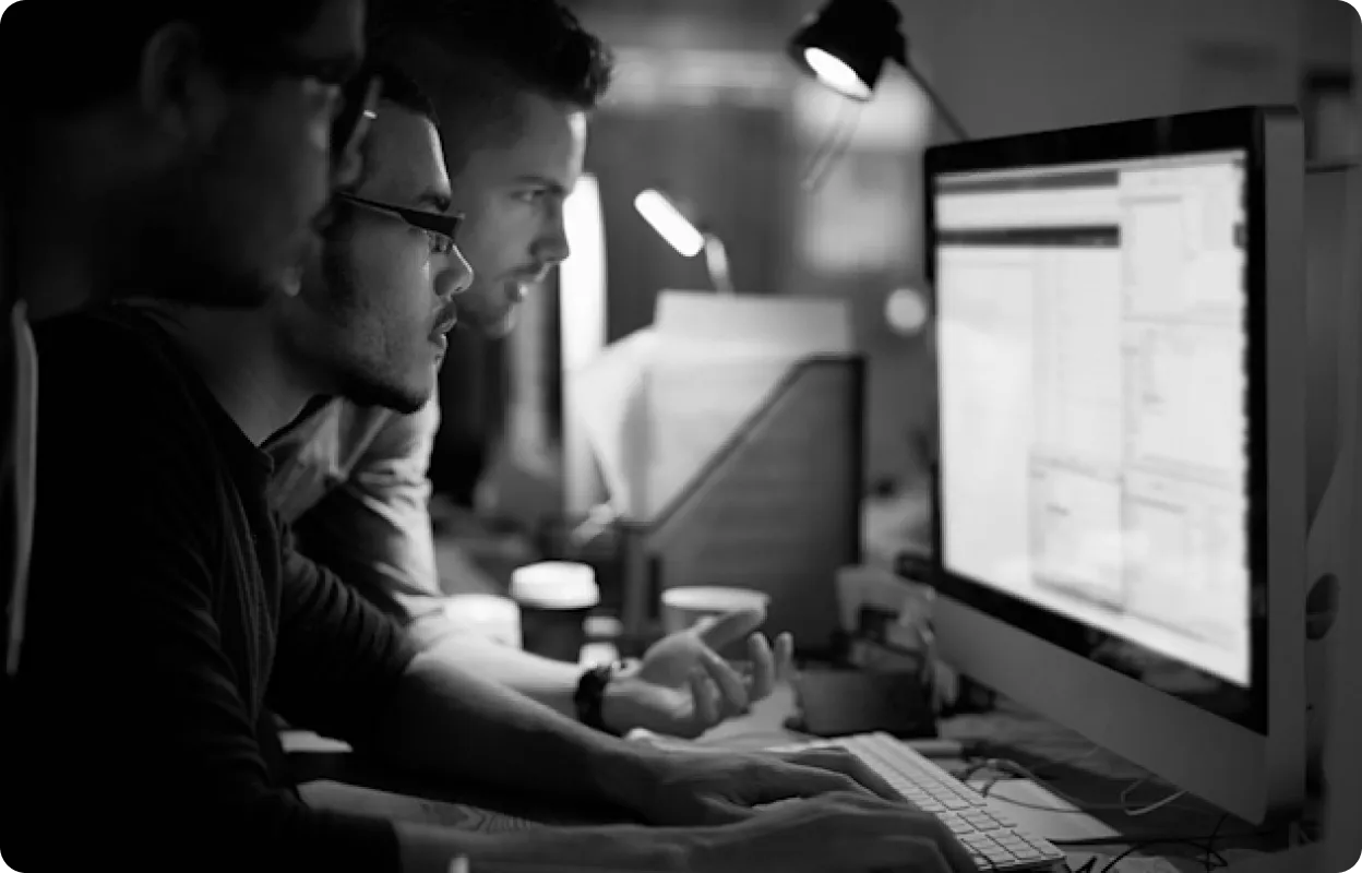 Two professionals analyzing marketing data on screens