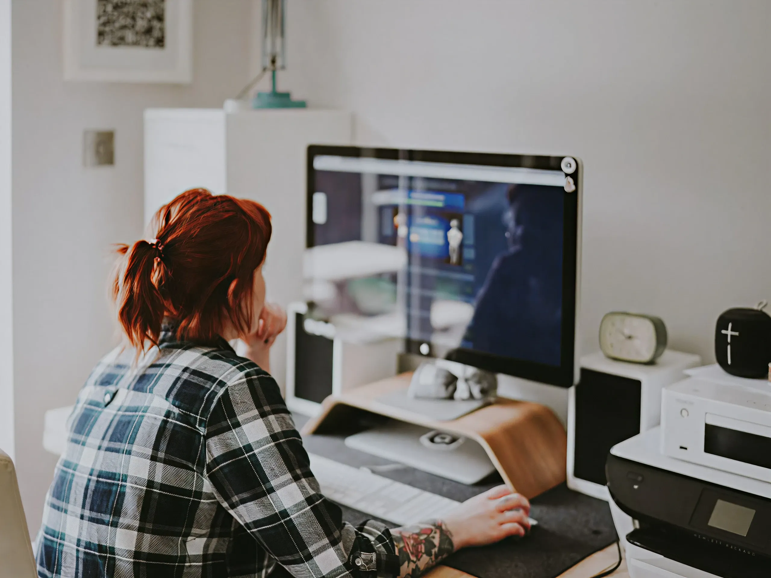 Woman working on localized content at desk — scale from one platform