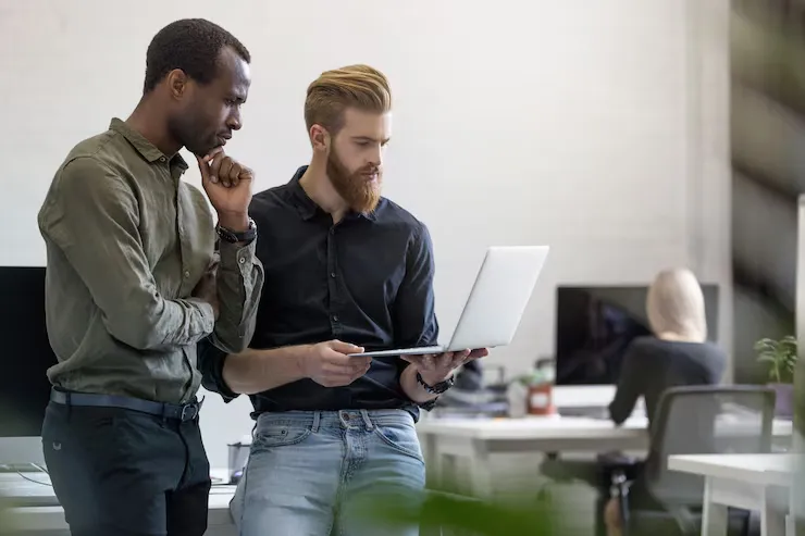 Two professionals collaborating on analytics