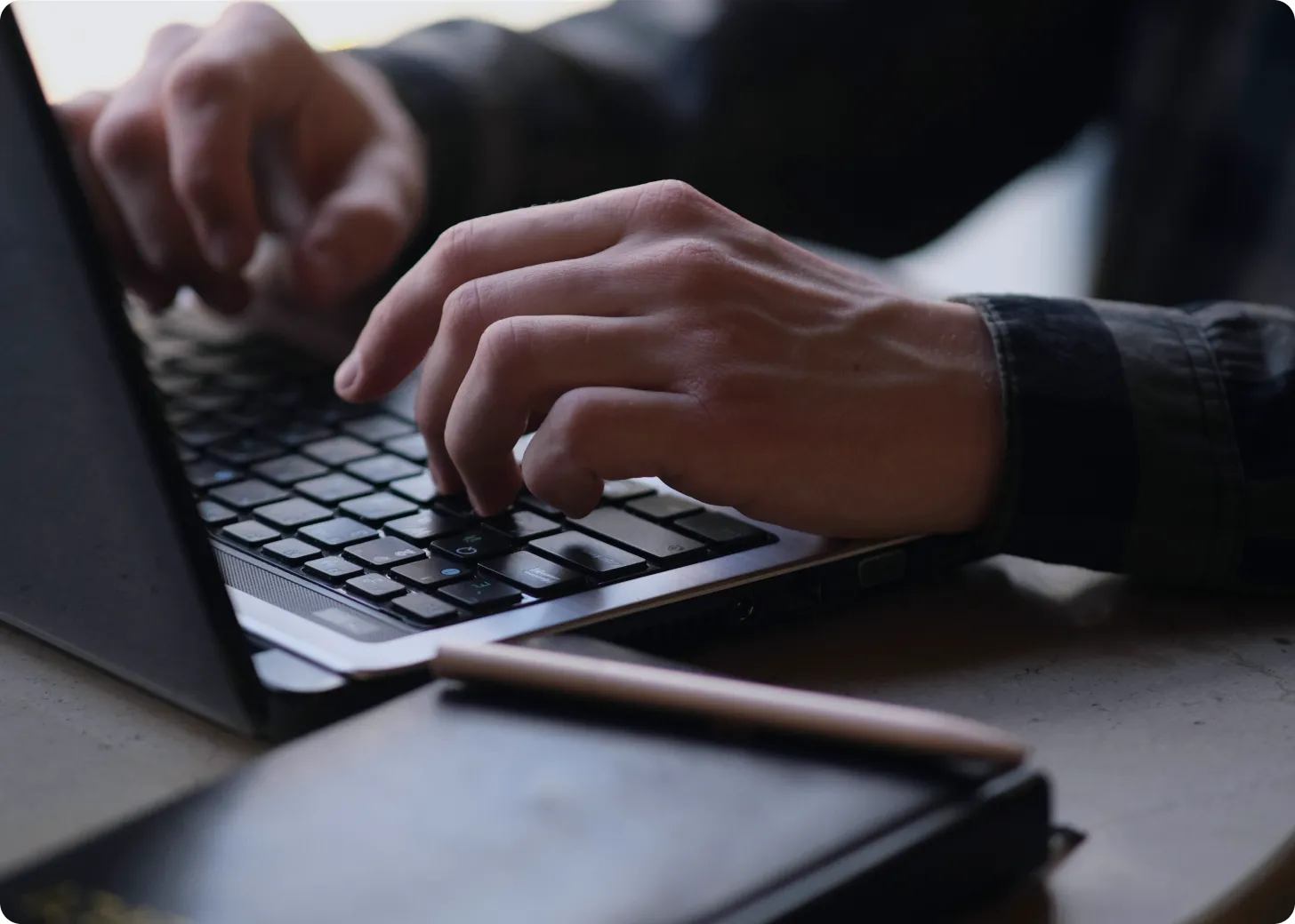 Developer typing on laptop keyboard