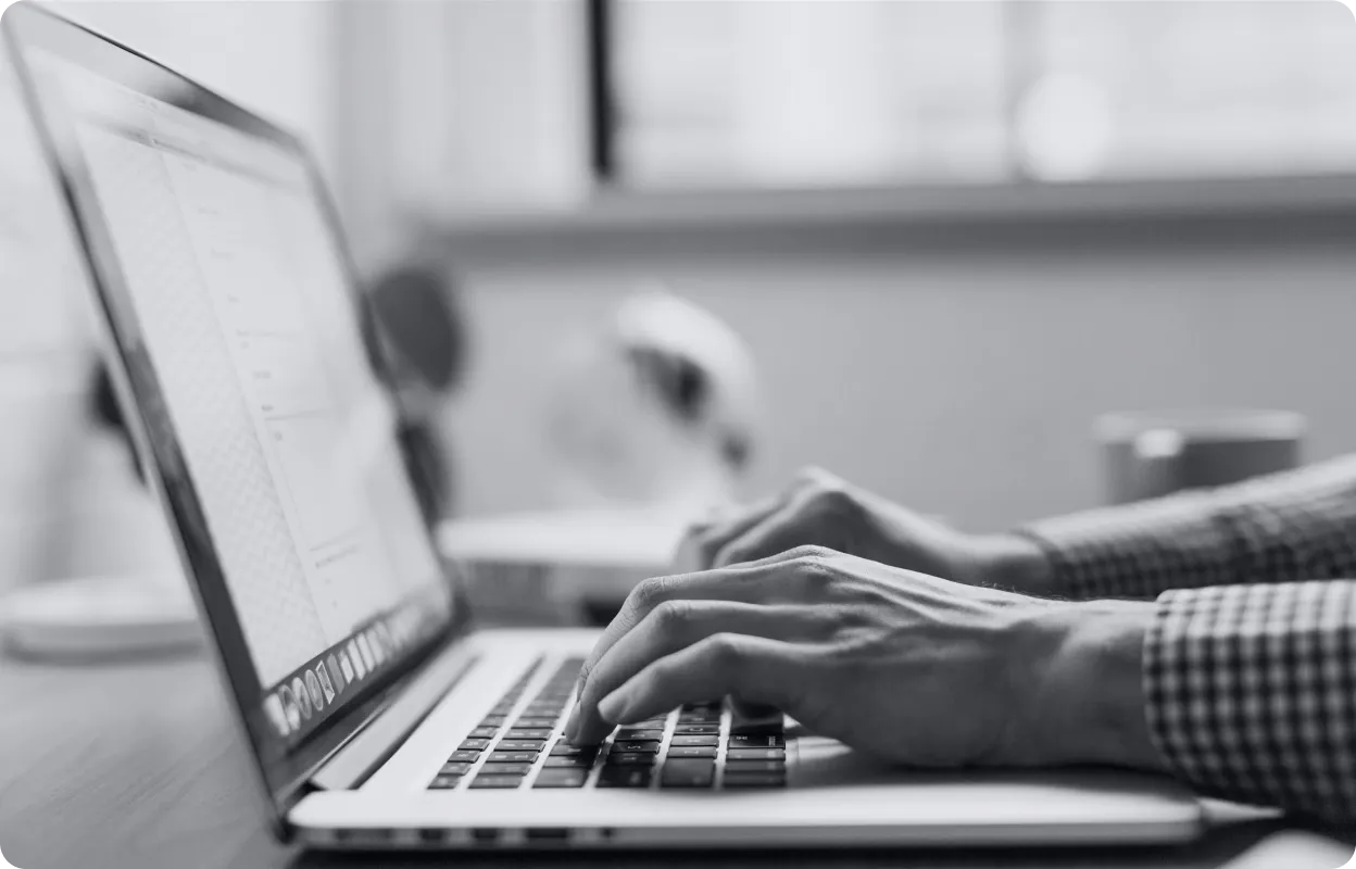 Professional typing on laptop